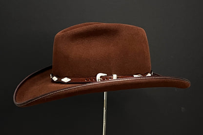 Copper colored western pinch hat with silver concho and leather hatband